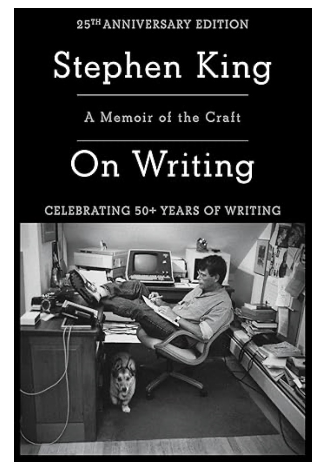 Stephen King sitting at his writing desk